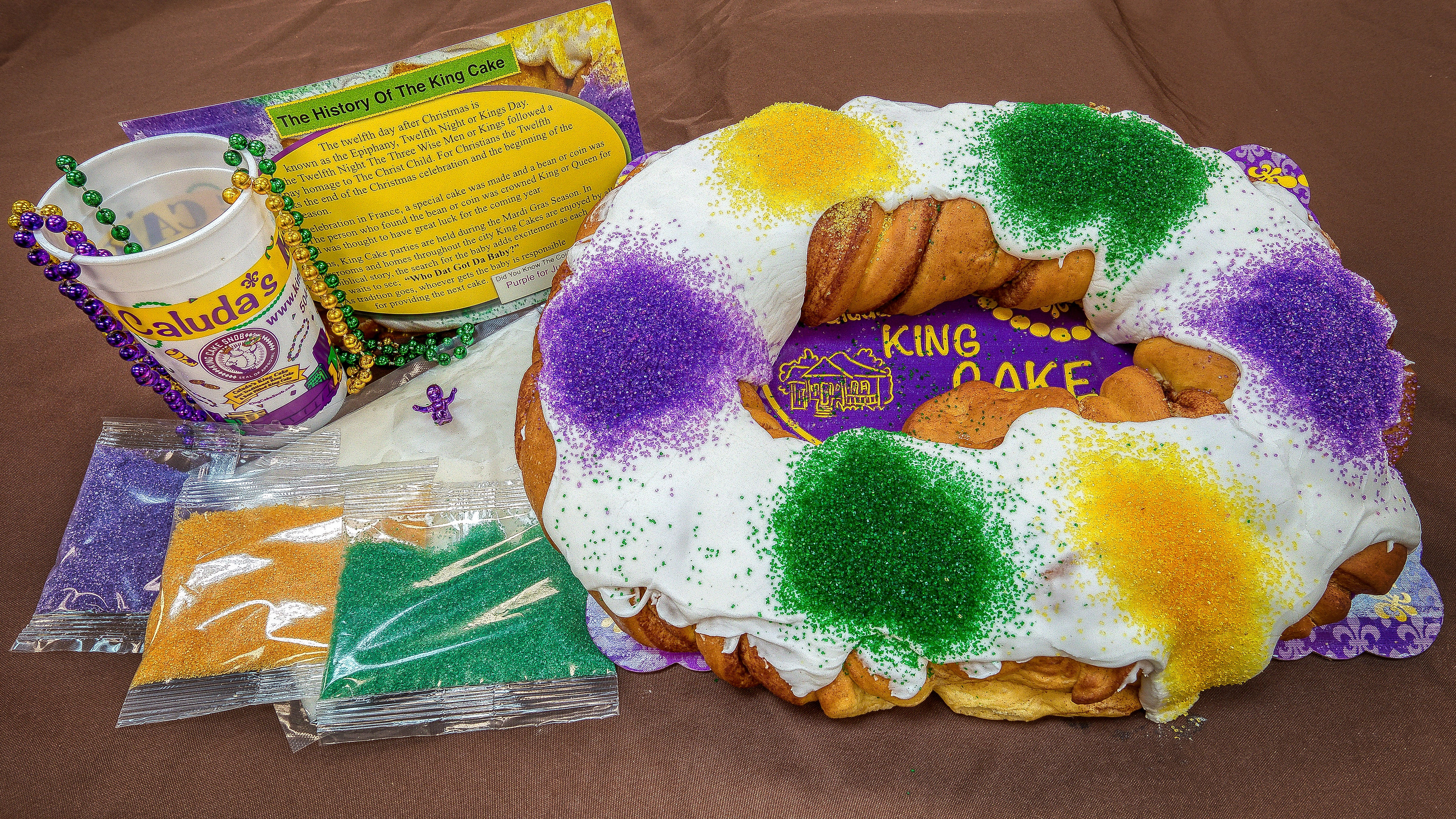 King Cake  Recipe history and tutorial for making this colorful braided  Mardi Gras cake from food his  King cake recipe King cake history Mardi  gras king cake